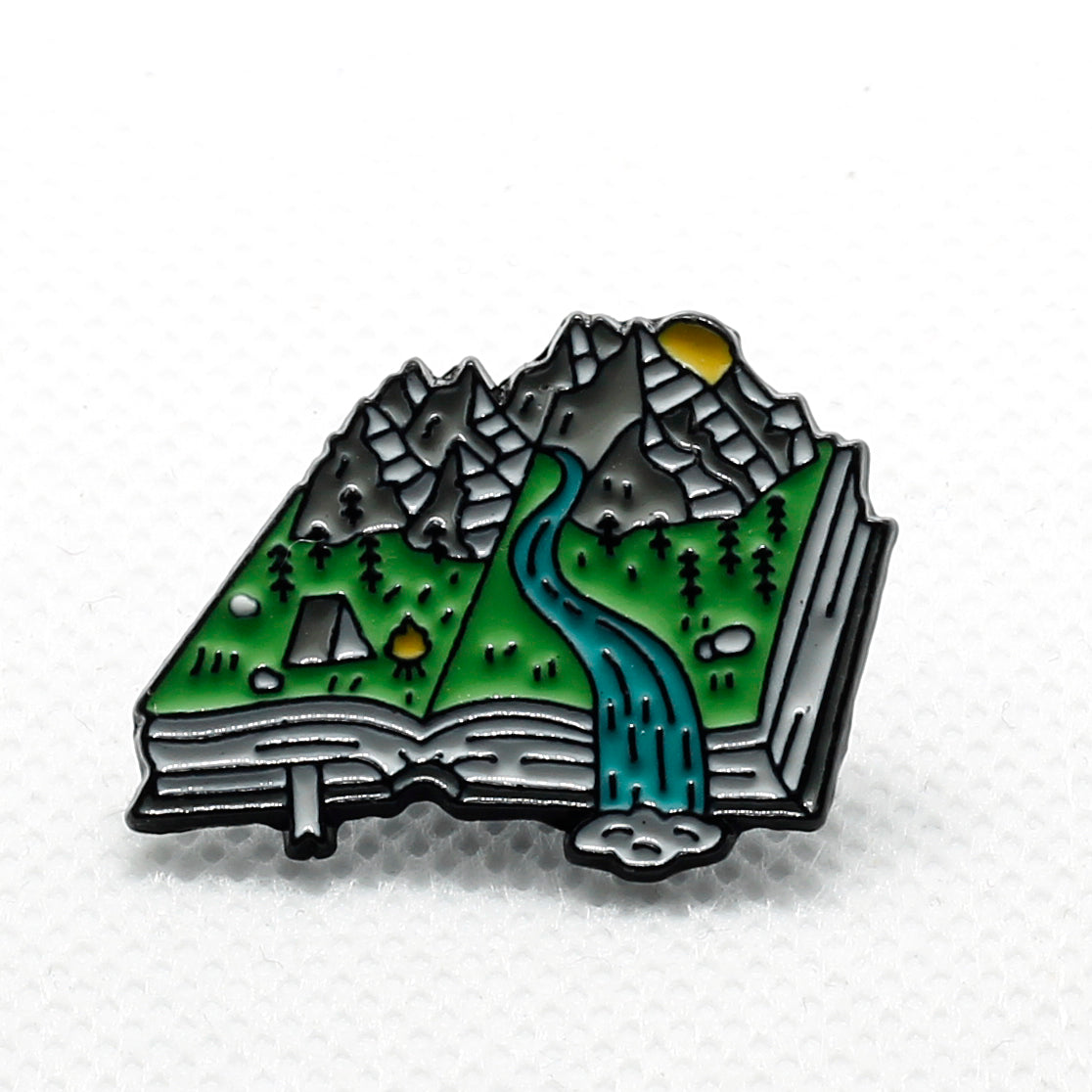 book with mountains and river badge